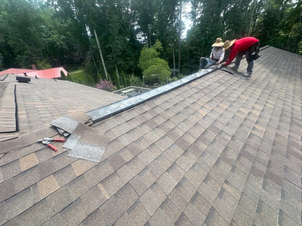 Emergency Roofing Solutions crew installing ridge vent on a Buford, GA roof replacement