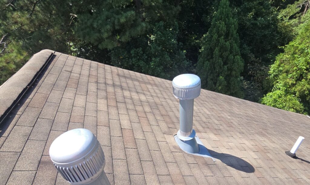 Roof vents and shingles during a community roof inspection in Doraville, GA
