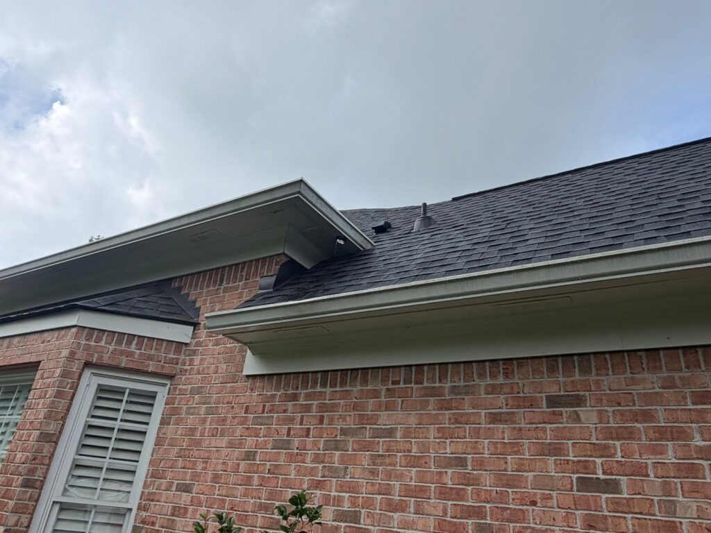 Shingle roof and gutters on a Roswell, GA brick home by Emergency Roofing Solutions